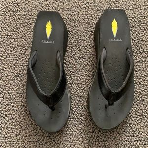 Volatile black platform flip flops
